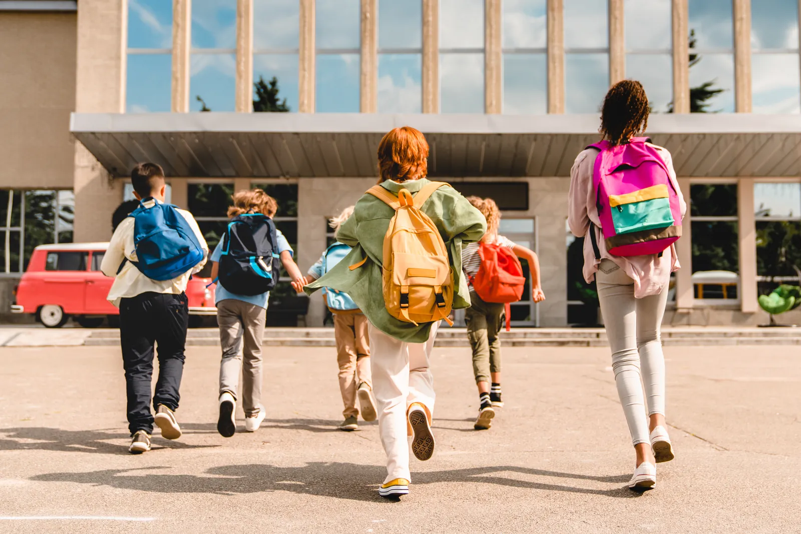 Students with backpacks arriving at school