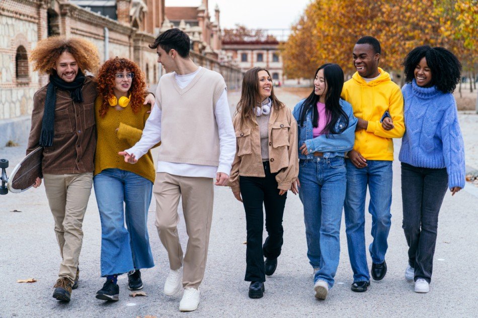 a group of young people walking together and having fun